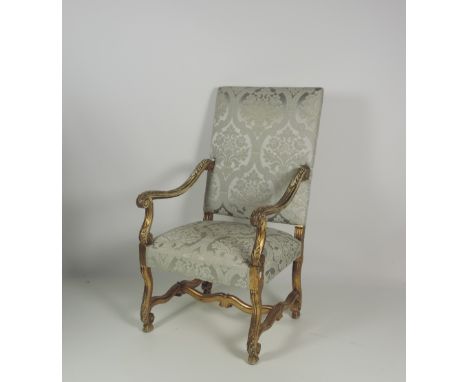 A large and impressive late 19th Century carved giltwood Armchair, with carved scroll arms, similar legs and shaped stretcher