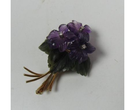 An unusual small 14ct gold Brooch, in the shape of a flower bouquet made from amethyst, dark green stone and studded with thr