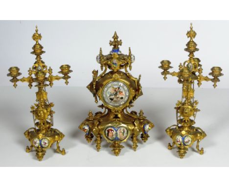 An attractive 19th Century French ormolu and gilt metal Clock Garniture, the clock with embossed and engraved decoration and 