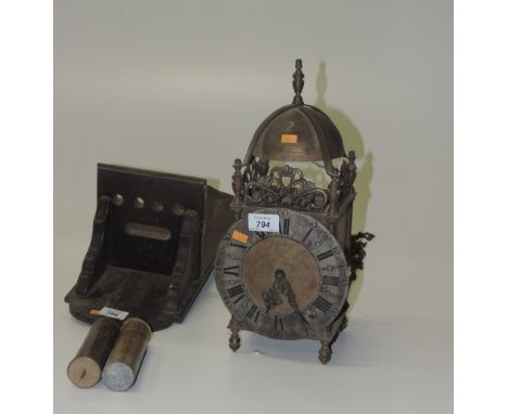 An engraved brass Lantern Clock, in the Charles II style, the decorated pierced cornice over engraved sides, and clock face i