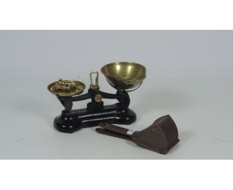 A small heavy brass and metal Shop Scales, with brass weights, and an old metal garlic press. (2)