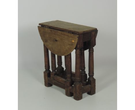 An unusual early 19th Century small oak gate-leg Table, with turned supports. (1)