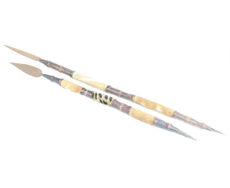 A West African spear, having an iron tip with hide covered and leather bound wooden shaft and spiked base, 96cm, together wit