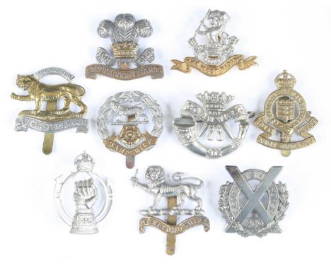 A collection of assorted cap badges and insignia to include Royal Armoured Corps, Artists Rifles, Herefordshire Regiment, The