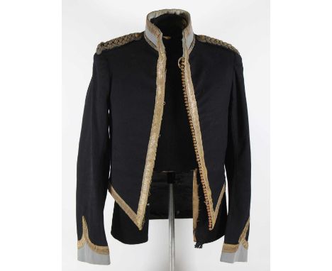 An early 20th century British Army Mess uniform, the jacket in black cloth with blue facings and bullion embroidered banding,