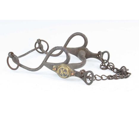 A WW I French Artillery horse bit, the S-shaped side bars with brass roundells embossed with crossed cannons and grenade, w.1