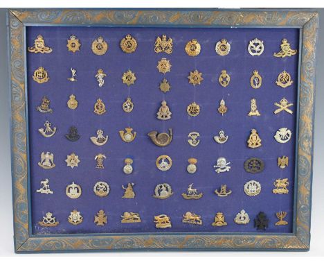 A collection of assorted cap badges and insignia to include The Royal Artillery, Machine Gun Corps, Suffolk Regiment, Northam