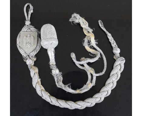 A German Third Reich first pattern army marksmanship lanyard, of typical knotted construction with alloy shield, L.44cm, toge