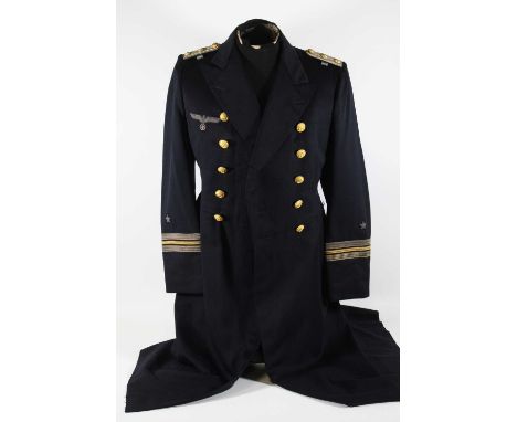 A German Third Reich Kriegsmarine Officers frock coat, in dark blue cloth with bullion embroidered breast eagle and gilt butt