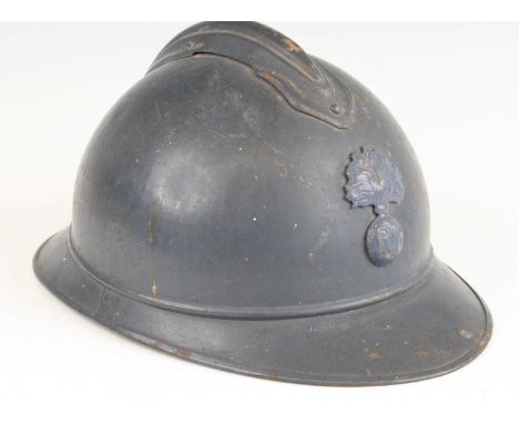 A French M15 Adrian pattern helmet, in blue finish with flaming grenade badge, having a black leather liner and brown chin st