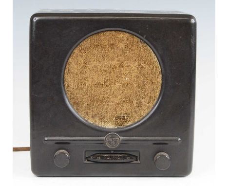 A German Third Reich Deutscher Kleinempfänger (small receiver), the bakelite case with cloth speaker grille above a central e