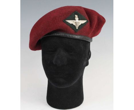 A WW II 7th Battalion (Light Infantry) Parachute Regiment maroon beret, with Parachute Regiment cap badge on green cloth back