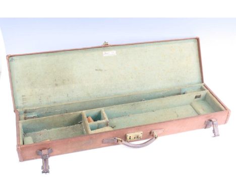 A mid-20th century shotgun case covered in brown canvas with leather trim, having a green felt lined interior with ivorine tr