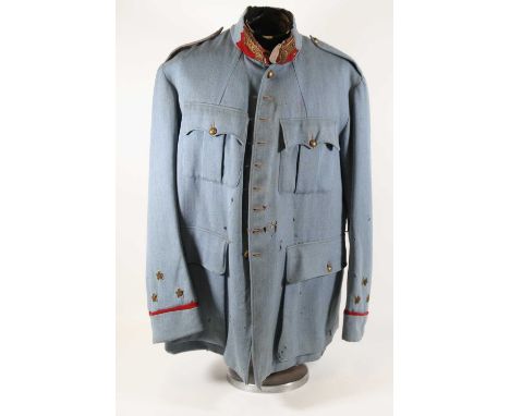 A WW I French Officers tunic, in blue cloth the scarlet backed collar with bullion embroidery, having four front pockets and 