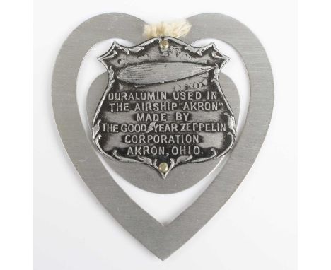 A bookmark, of heart shape with central shield embossed with an airship and marked Duralumin used in the airship "Akron" made