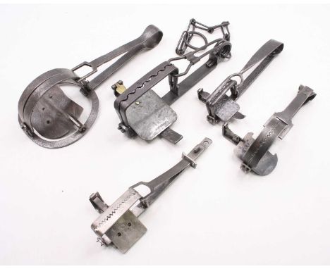 A group of fourteen gin traps to include Robert Patent Dogless gin trap, 25cm overall, sidebottoms 5 inch trap, S. Lewis & Co