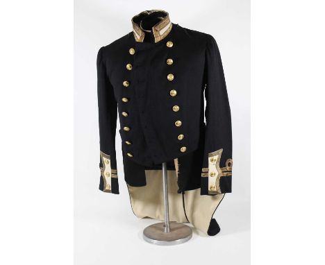 A British Royal Naval Officers tailcoat in black fabric with gold bullion collar and cuffs, having two rows of eight front fa
