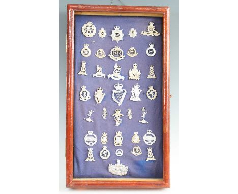 A collection of assorted modern cap badges and insignia to include Gloucestershire Regiment, Tank Corps, Royal Military Polic