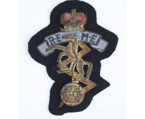 An REME bullion badge, together with three pairs of REME cap badges. (7)