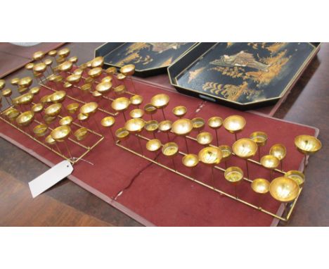 TEA LIGHT HOLDERS, a set of three, in gilded metal, each for thirty lights, 55cm x 19cm x 13cm H. (3)