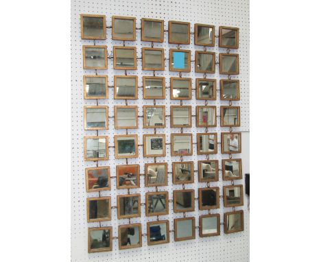 WALL ART, consisting of forty eight square mirrors in a gilded frame, 102cm x 76cm. 
