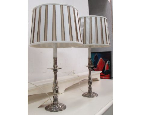 LAMPS, a pair, polished metal candlestick form with silk shades, 70cm H. (2)
