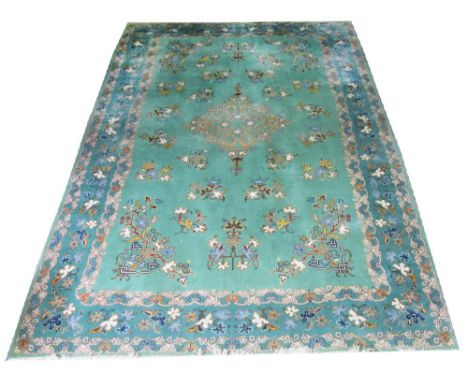 KASHAN CARPET, 220cm x 332cm, central medallion of leaves and flowers on a jade field with a corresponding border. 