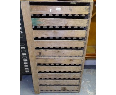 A set of 10 Vintage pine chitting trays in cabinet 
