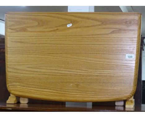 A modern Ercol drop leaf table, W67cm 