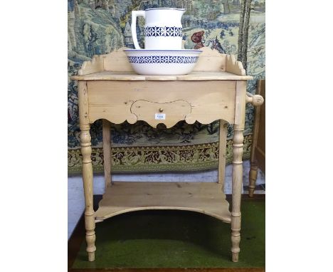 An Antique pine washstand with frieze drawer, together with a blue and white wash jug and basin 