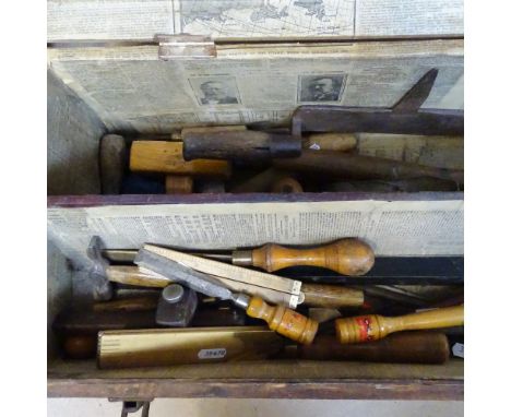 A stained wood tool chest, containing tools and rules 