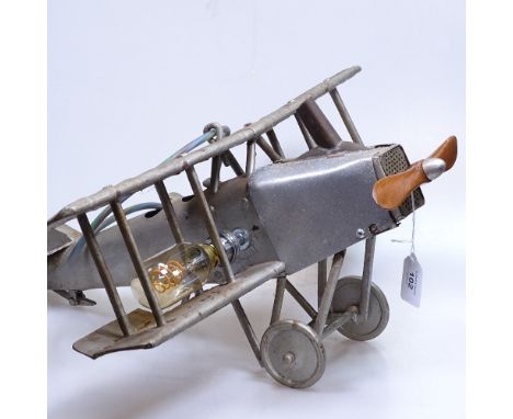 A tinplate bi-plane, length 50cm, converted to a table lamp 