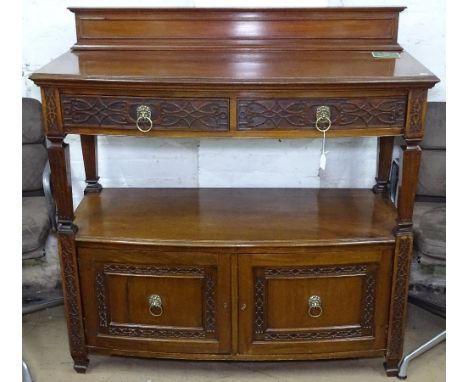 A Victorian mahogany bow-front buffet, with raised panel back, carved frieze drawers and cupboards under, W125cm, H125cm 