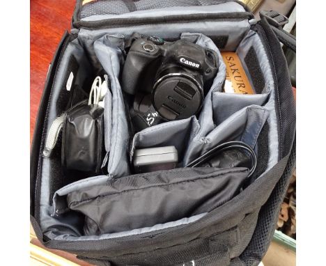 A Canon camera and accessories, binoculars etc 