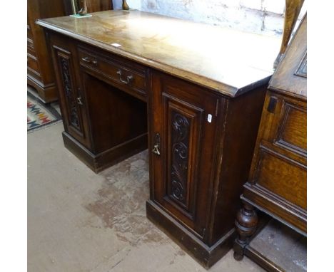 A Victorian walnut knee-hole writing desk, with single drawer, flanked by acanthus leaf carved panel cupboards, on a plinth b