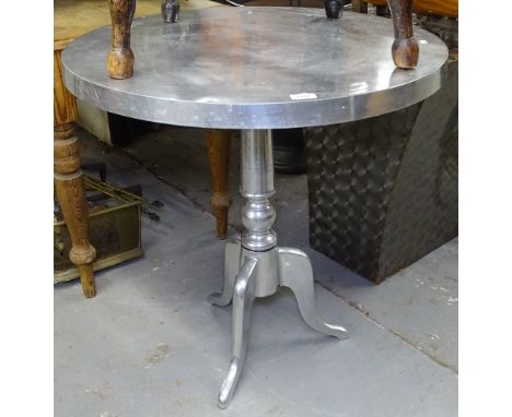 A circular chrome pub table on tripod base 