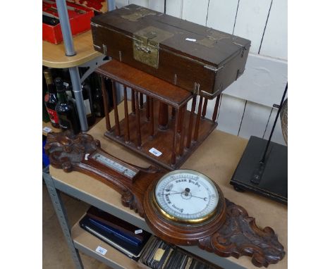 A brass-mounted Oriental box, length 40cm, a mahogany revolving bookcase, and a carved oak-cased aneroid barometer 