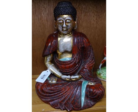 A Vintage painted and gilded ceramic Buddha, height 25cm 