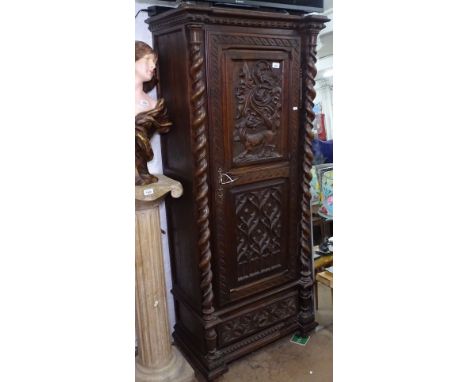 A 19th century carved oak hall cupboard, with single panel door and barley twist pillisters, W71cm, H70cm 