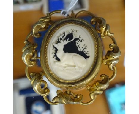 A Victorian gilt-metal brooch, with carved ivory stag mourning panel and hair panel to the reverse 