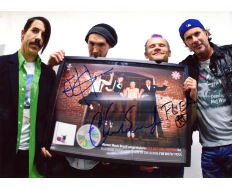 RED HOT CHILI PEPPERS: Signed colour 10.5 x 8 photograph by three members of the American rock band individually, comprising 