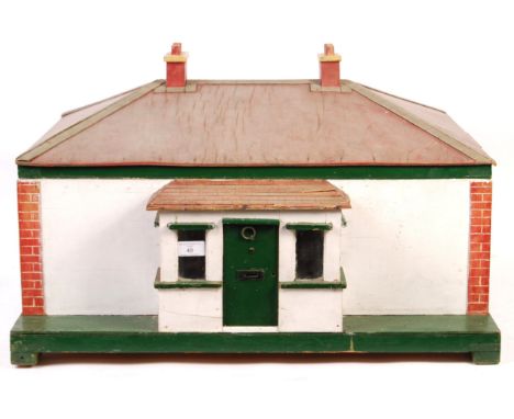 A charming 1940's wooden child's doll's house bungalow. Lift-up roof, revealing four rooms and a central hallway. Opening win