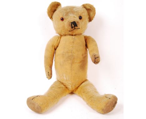 An original vintage 1930's Hygienic Merrythought Toys golden mohair soft toy teddy bear having jointed limbs, orange and blac