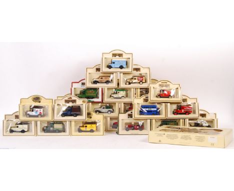 A collection of assorted Lledo Days Gone scale diecast model vehicles with advertising decals including a Famous Stores Of Lo