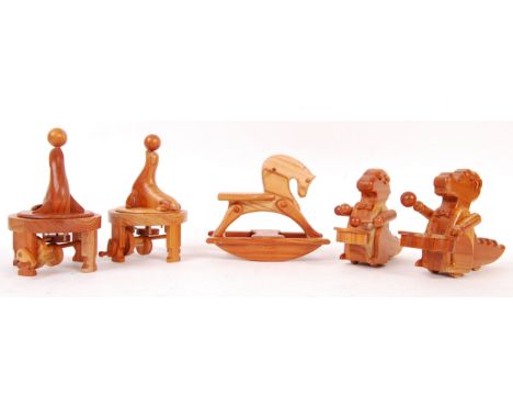 A collection of Chester Wedgewood's handmade wooden carved figures to include; 2x drumming dinosaurs, a miniature rocking hor