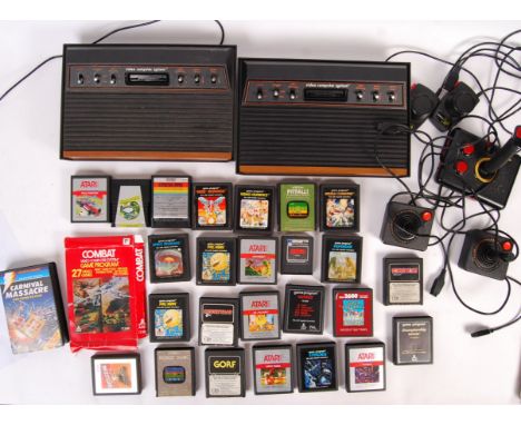 A collection of vintage Atari related games consoles, games and accessories. To include; 2x Atari 2600 ' Woody ' consoles, wi