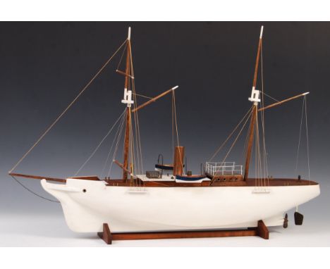 A rare antique vintage live steam model boat. Based on a twin-masted tall ship, the boat comes fitted with a single cylinder 