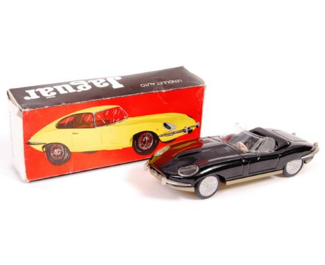 An original vintage Hungarian made ' Lemezary Gyar ' tinplate friction powered model E-Type Jaguar. Black, with windscreen an