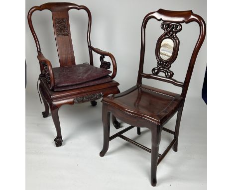 TWO CHINESE CHAIRS,One armchair with carved dragon head arms on four legs terminating in claw and ball feet. The other a side