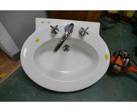 Oval shaped sink with taps
